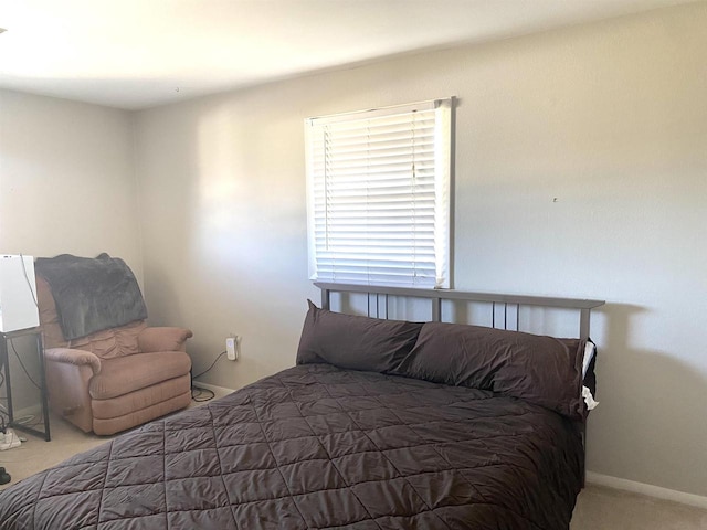 carpeted bedroom featuring baseboards