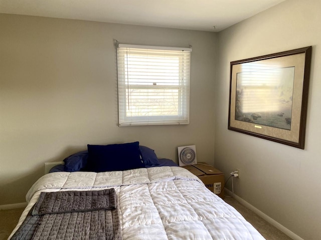 carpeted bedroom with baseboards