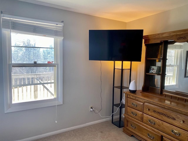 bedroom featuring baseboards and light carpet