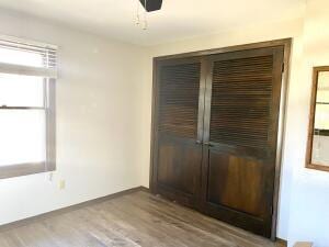 unfurnished bedroom with a closet and wood finished floors