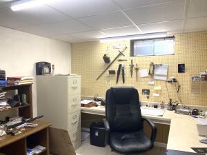 office with a drop ceiling and a workshop area