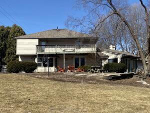 rear view of house with a yard and a wooden deck