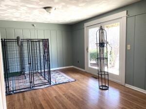 entrance foyer with baseboards and wood finished floors