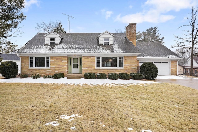 cape cod home with a front yard, a chimney, driveway, stone siding, and an attached garage