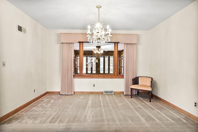 carpeted spare room featuring a notable chandelier, visible vents, and baseboards