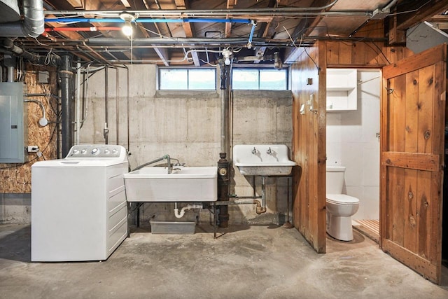 basement with electric panel, washer / clothes dryer, and a sink