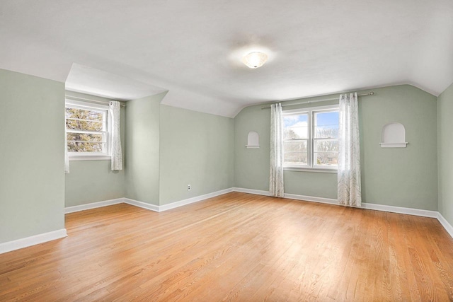 additional living space with a wealth of natural light, light wood-type flooring, and baseboards