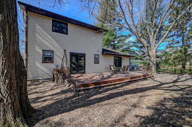 rear view of property featuring a deck