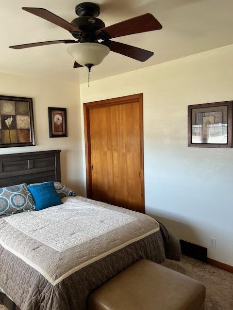 bedroom featuring a closet, baseboards, and ceiling fan