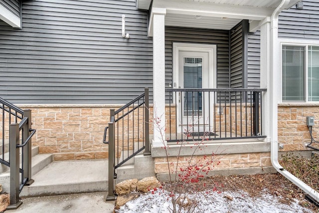 property entrance featuring stone siding