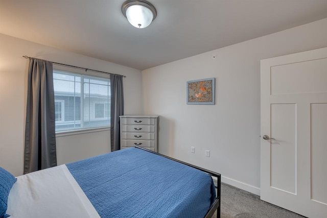 bedroom with baseboards and carpet flooring