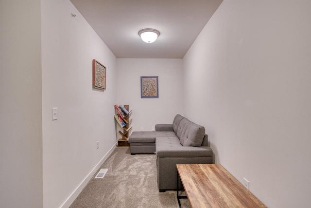 sitting room featuring visible vents, carpet floors, and baseboards