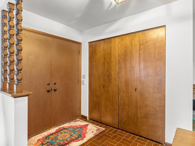 entrance foyer featuring brick floor