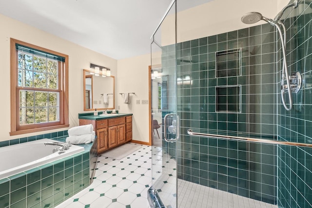 bathroom with vanity, a bath, and a shower stall