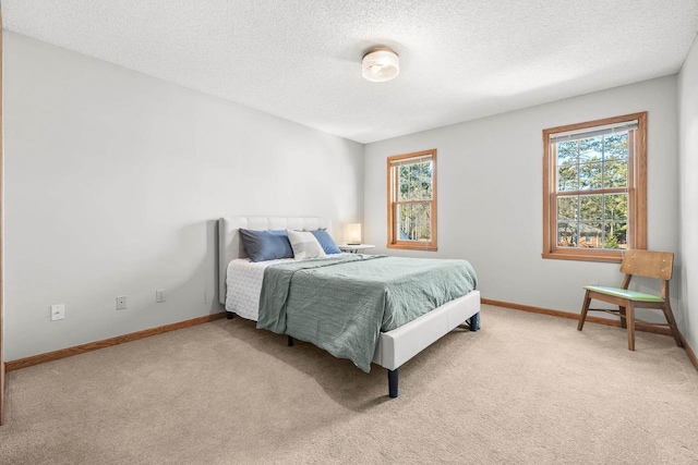 bedroom featuring baseboards, multiple windows, and carpet flooring