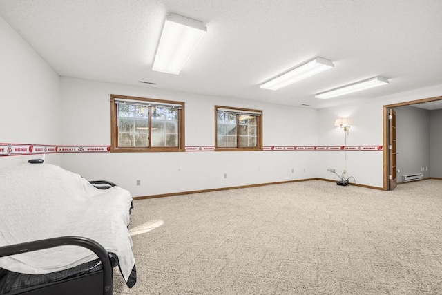 interior space with baseboards, carpet floors, and a textured ceiling