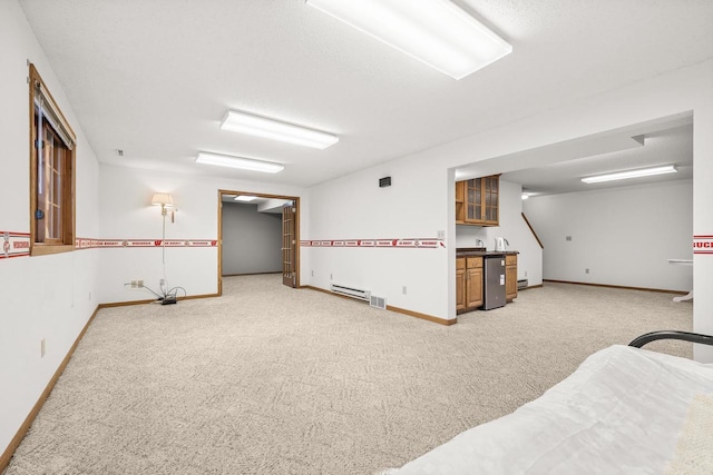 interior space with light carpet, visible vents, baseboards, and a baseboard radiator