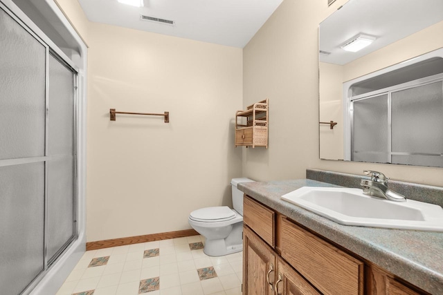 bathroom featuring visible vents, a shower stall, baseboards, toilet, and vanity