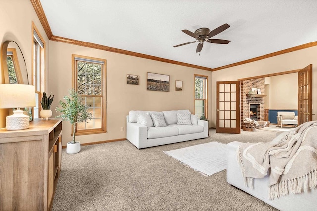 living area with carpet, crown molding, a brick fireplace, and a healthy amount of sunlight