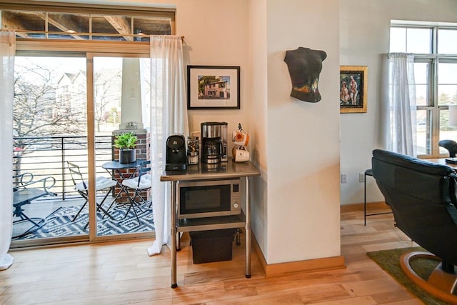 interior space featuring baseboards and wood finished floors