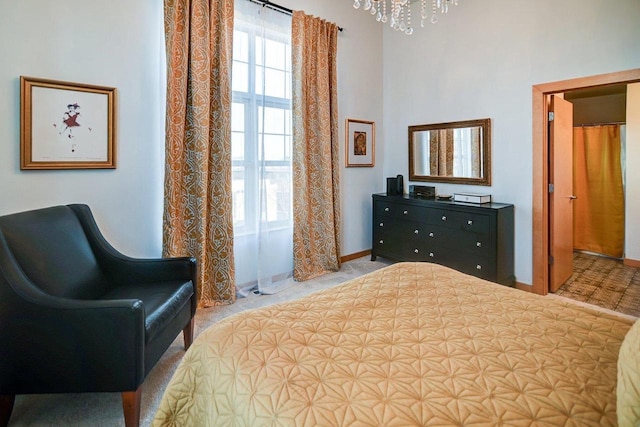 bedroom with baseboards and an inviting chandelier