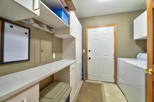 clothes washing area with washing machine and clothes dryer, cabinet space, and light floors