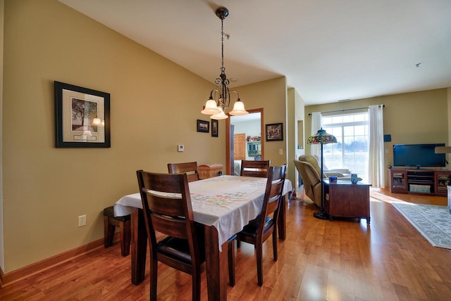 dining room with an inviting chandelier, wood finished floors, and baseboards