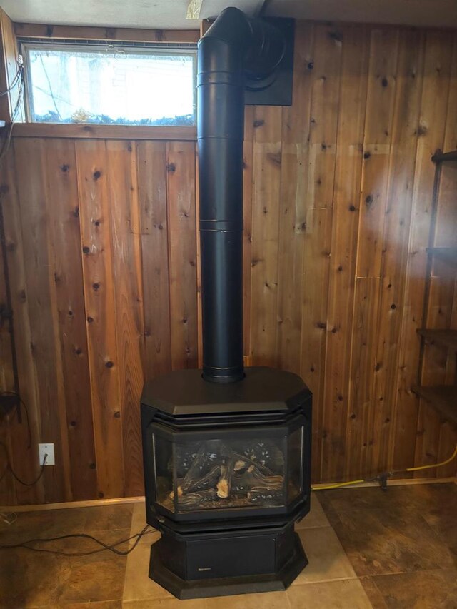 room details featuring a wood stove and wooden walls