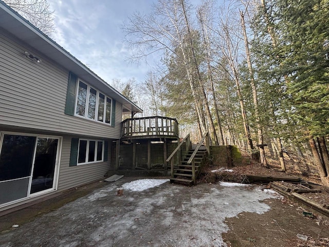 exterior space with stairway, a wooden deck, and a patio