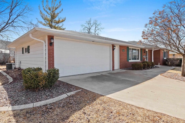 ranch-style home with a garage, brick siding, central AC unit, and concrete driveway