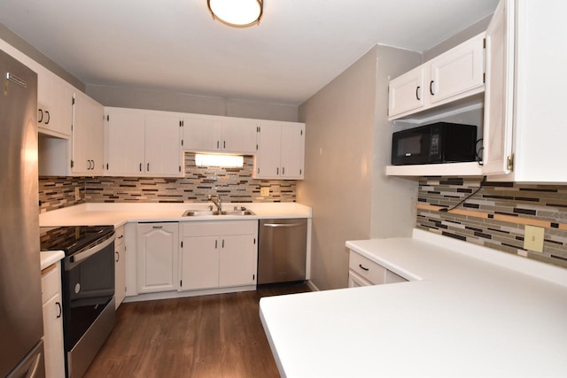 kitchen with white cabinets, appliances with stainless steel finishes, and a sink