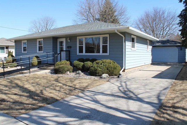 ranch-style house featuring an outbuilding, roof with shingles, and fence