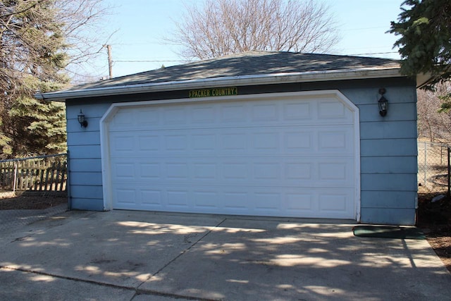 detached garage featuring fence