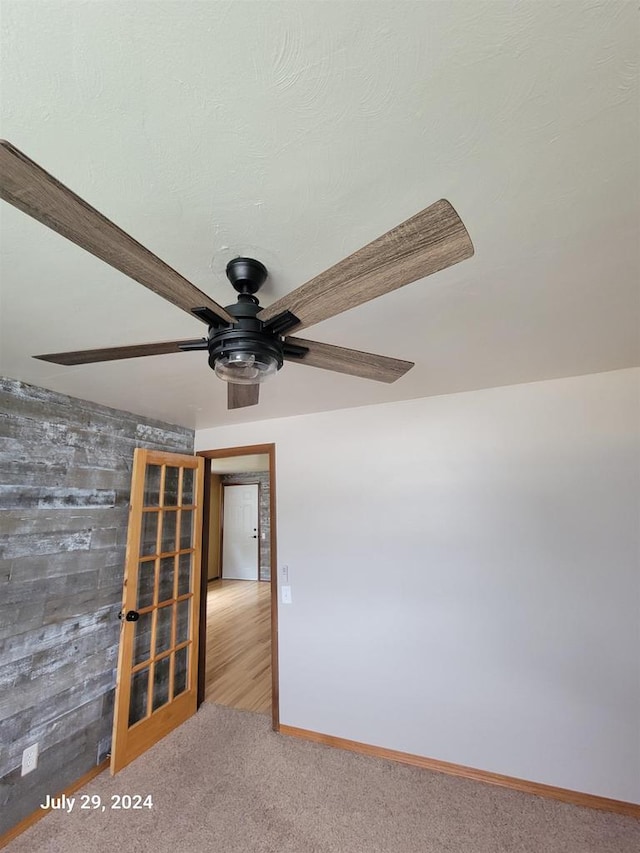 carpeted spare room featuring baseboards