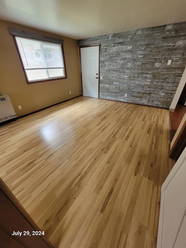 spare room with wood finished floors