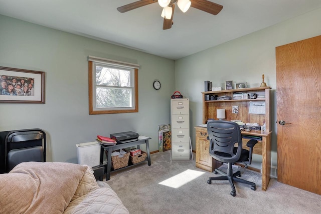 office space with a ceiling fan and carpet