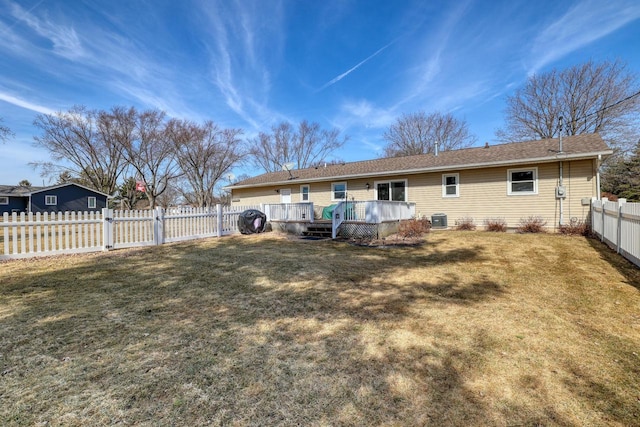 rear view of property with a yard, central AC, a wooden deck, and a fenced backyard