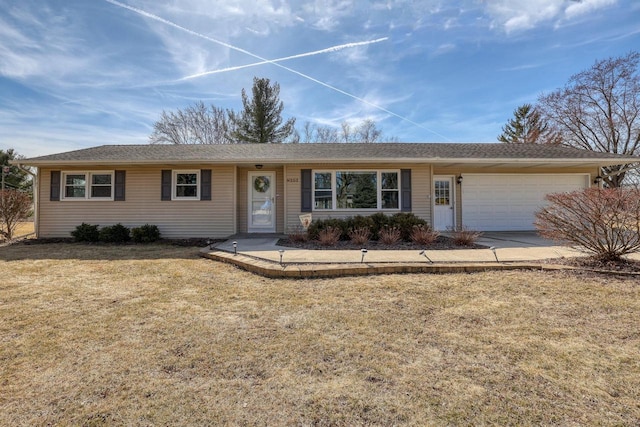 ranch-style home with an attached garage, concrete driveway, and a front yard