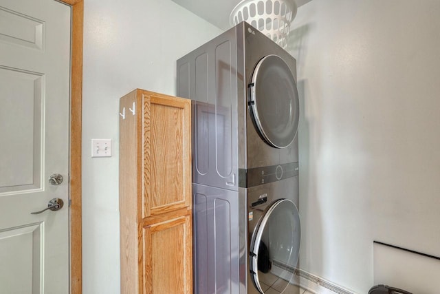 laundry room with stacked washing maching and dryer