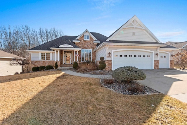 view of front of house featuring stone siding, an attached garage, concrete driveway, and a front lawn