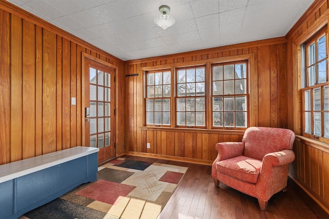 living area featuring hardwood / wood-style flooring and wood walls