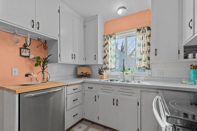 kitchen featuring a sink, white cabinets, light countertops, light floors, and dishwasher