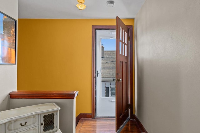 interior space with baseboards and wood finished floors