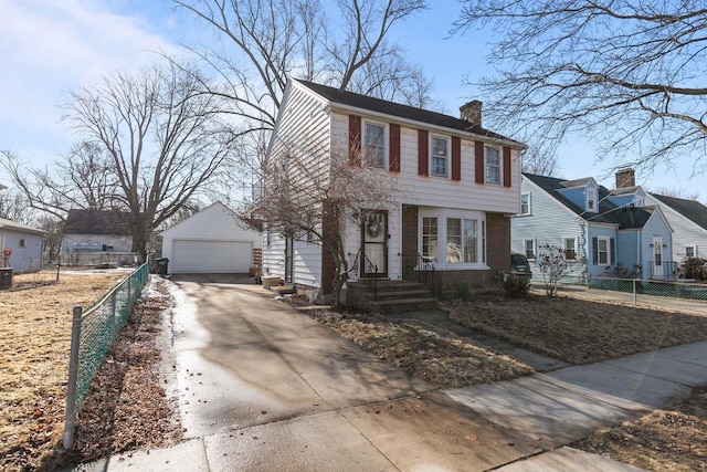 colonial house with an outbuilding, fence, a garage, brick siding, and a chimney