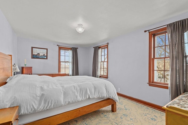 bedroom featuring baseboards and wood finished floors