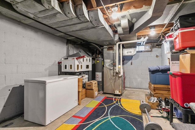 unfinished basement with fridge and water heater