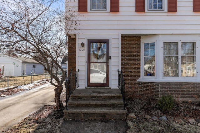 property entrance featuring brick siding