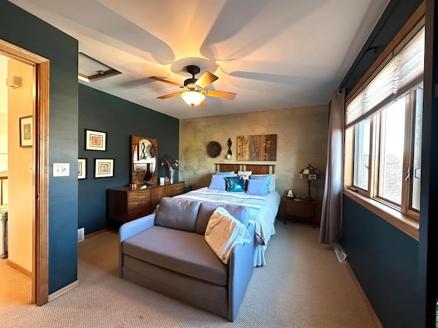 bedroom with attic access, carpet, baseboards, and ceiling fan