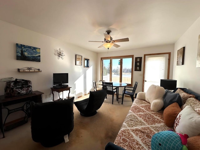 living room featuring ceiling fan and carpet floors