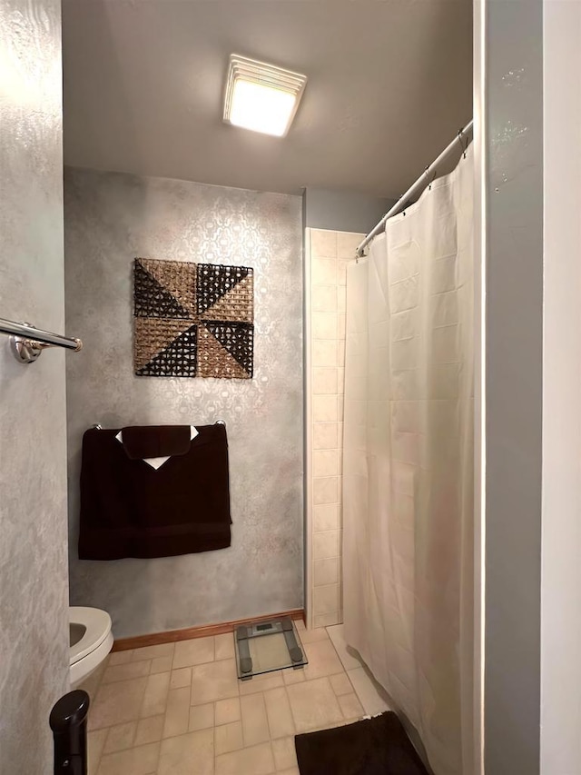 bathroom with a shower with shower curtain and toilet